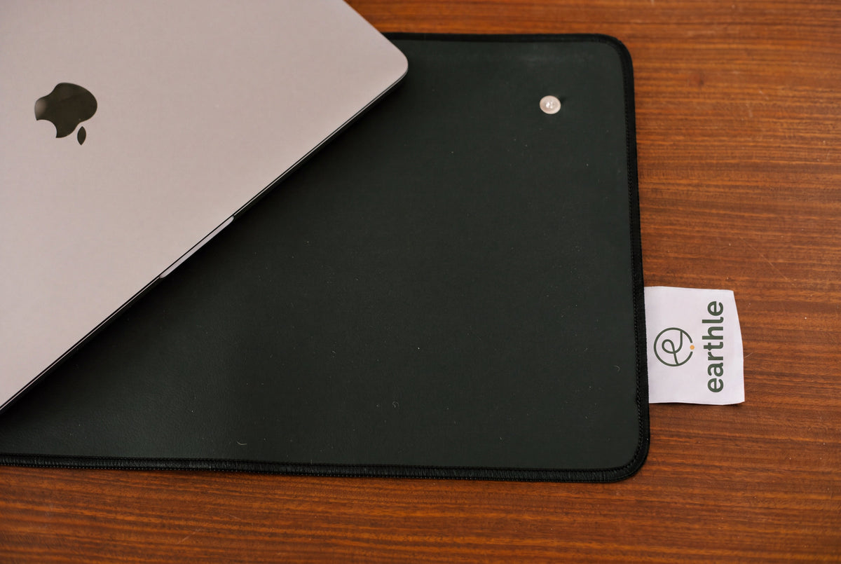 Laptop op de Earthle aardingsbureaumat op een houten bureau, van bovenaf gezien